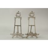 A PAIR OF SILVER PLATED PICTURE EASELS. 40cms long.