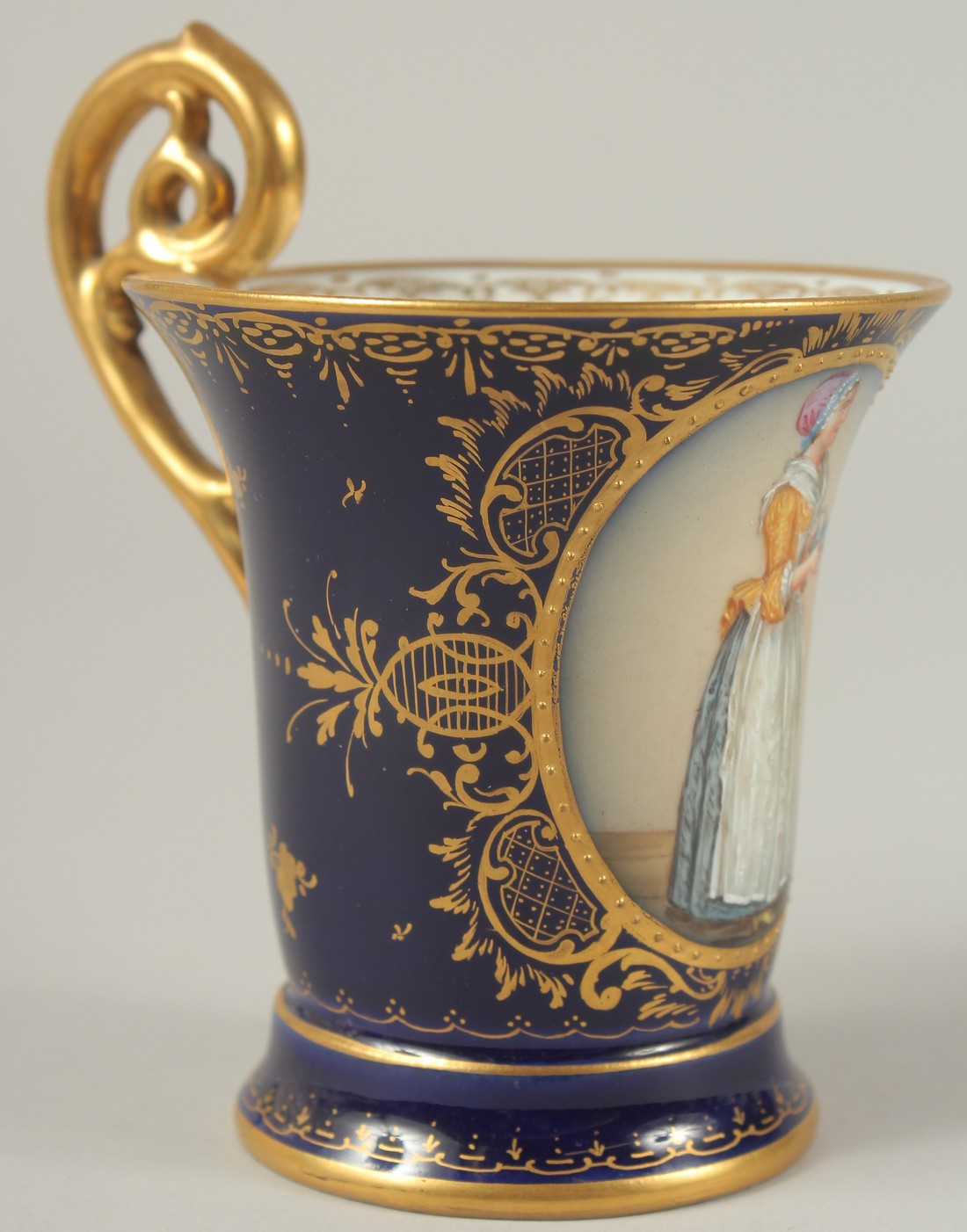 A GOOD DRESDEN CUP AND SAUCER with blue ground, painted with an oval of a lady carrying a tray. - Image 5 of 9