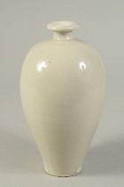 A CHINESE WHITE GLAZED DING WARE MEIPING VASE. 20.5cms high.