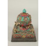 A TIBETAN DZI BEAD INLAID PRAYER ORNAMENT.