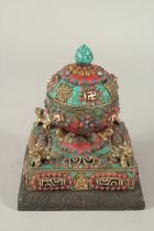 A TIBETAN DZI BEAD INLAID PRAYER ORNAMENT.