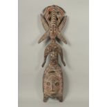 A PAINTED AND SPOTTED WOODEN TRIBAL FIGURE. 3ft long.