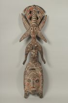 A PAINTED AND SPOTTED WOODEN TRIBAL FIGURE. 3ft long.