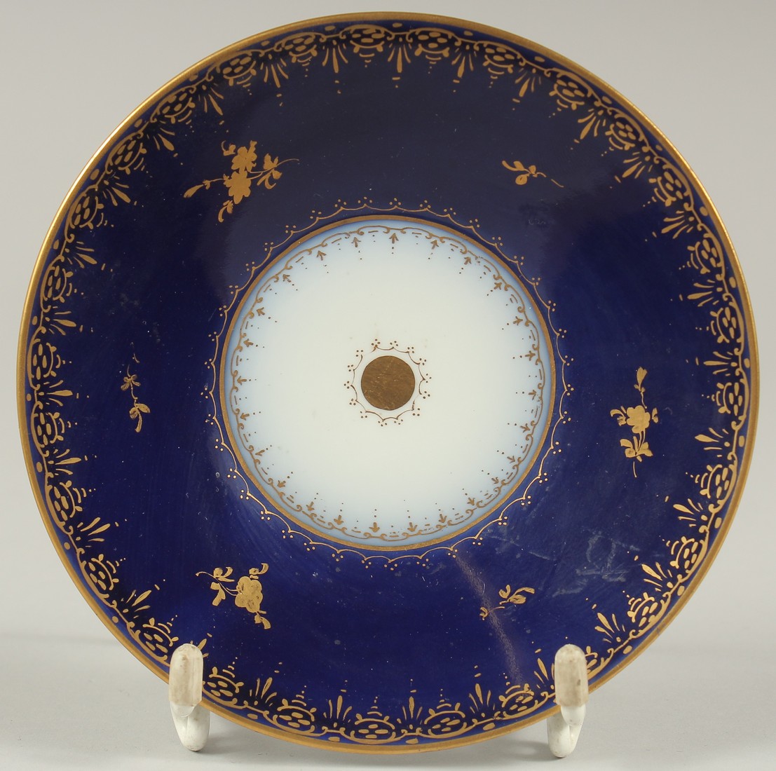 A GOOD DRESDEN CUP AND SAUCER with blue ground, painted with an oval of a lady carrying a tray. - Image 3 of 9