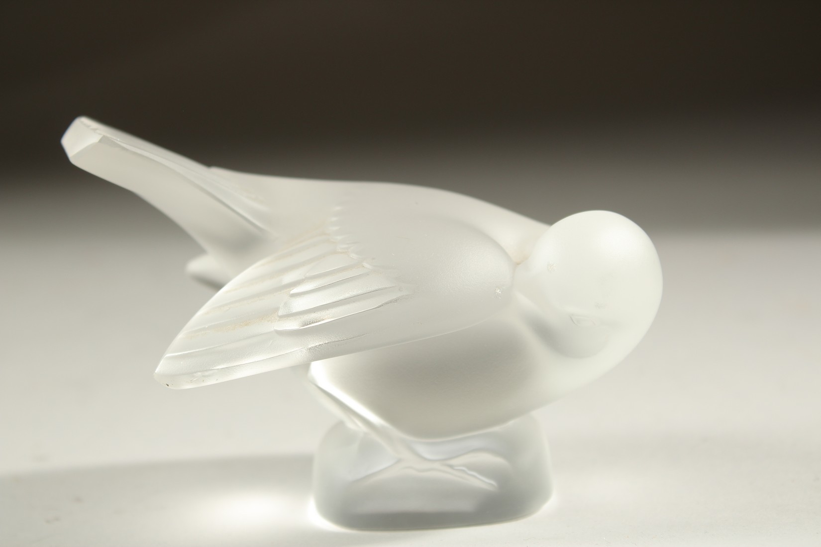 A LALIQUE FROSTED GLASS BIRD. 10cms. Etched R. Lalique, France.