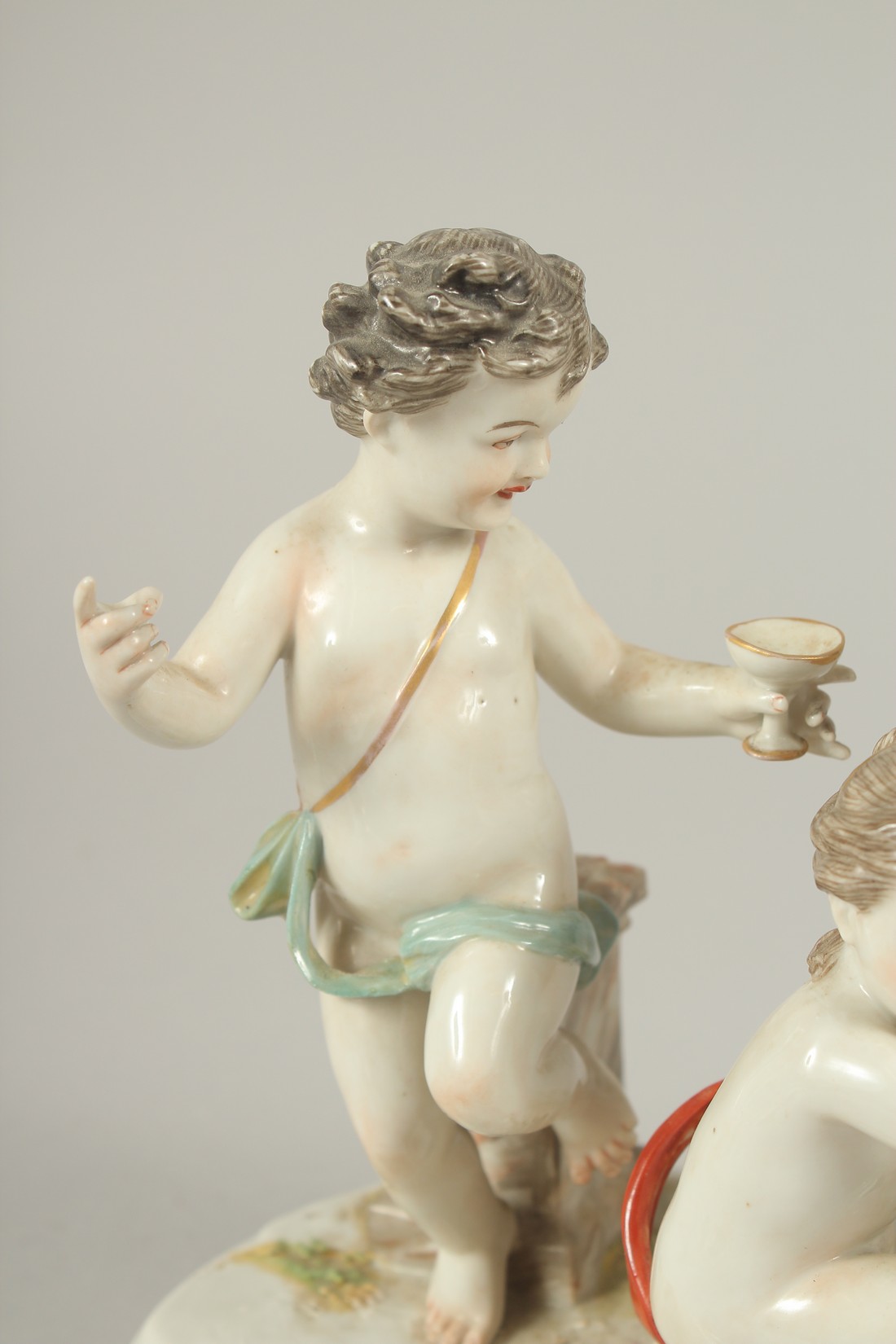A GOOD PORCELAIN GROUP OF THREE CUPIDS, with a large urn and grapes. 9.5ins long. - Image 2 of 7