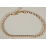 A GOOD 18CT YELLOW GOLD DIAMOND LINE BRACELET. 4ct of diamonds.