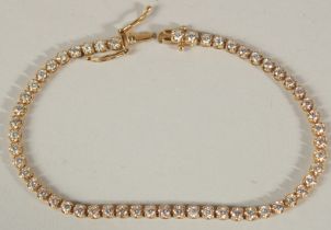 A GOOD 18CT YELLOW GOLD DIAMOND LINE BRACELET. 4ct of diamonds.