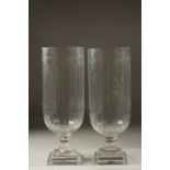 A PAIR OF CUT GLASS HURRICANE LAMPS on square stepped bases.