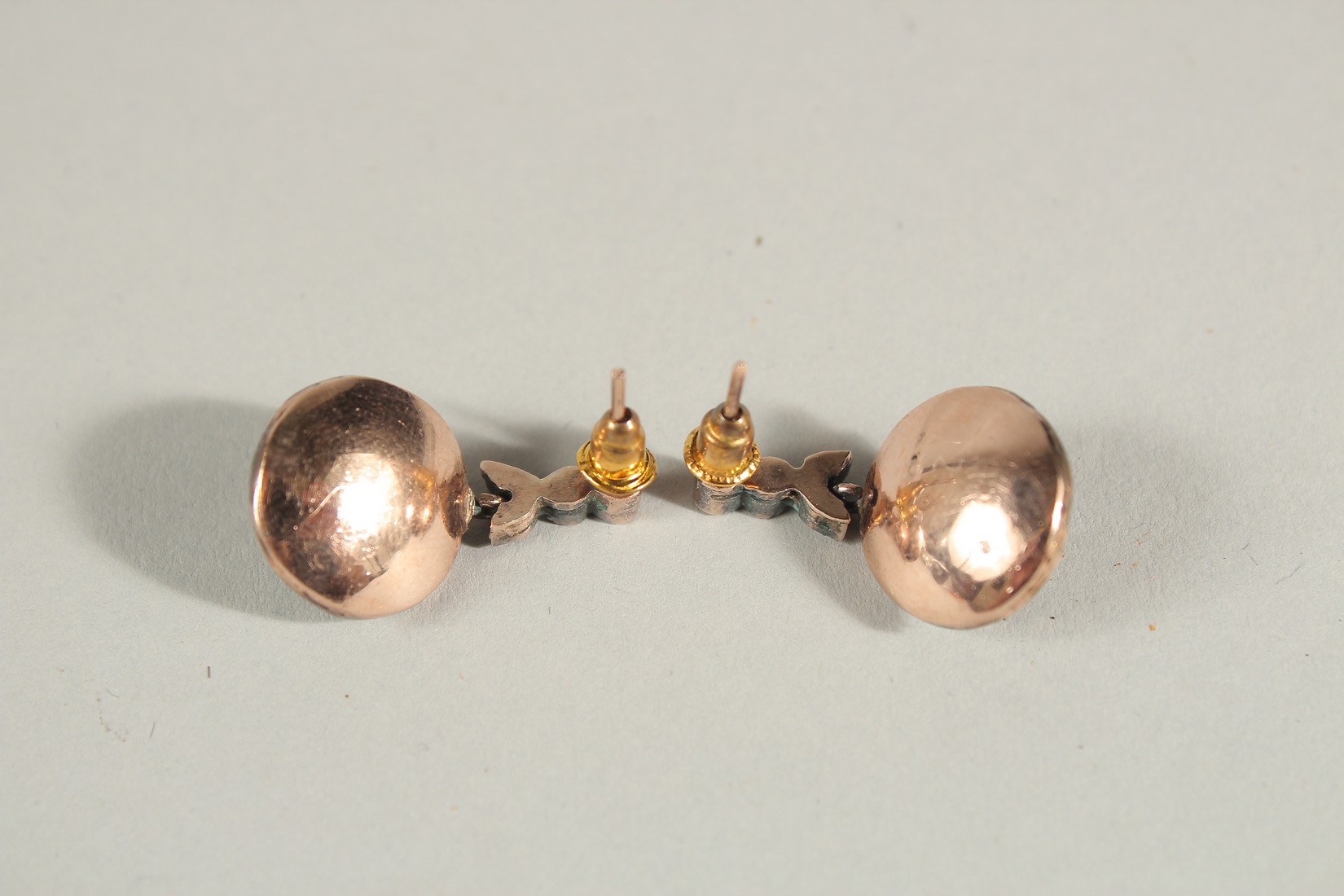 A PAIR OF UNHALLMARKED ROSE GOLD AND SILVER TOPPED TARGET STYLE DROP EARRINGS SET WITH CALIBRE - Image 2 of 2