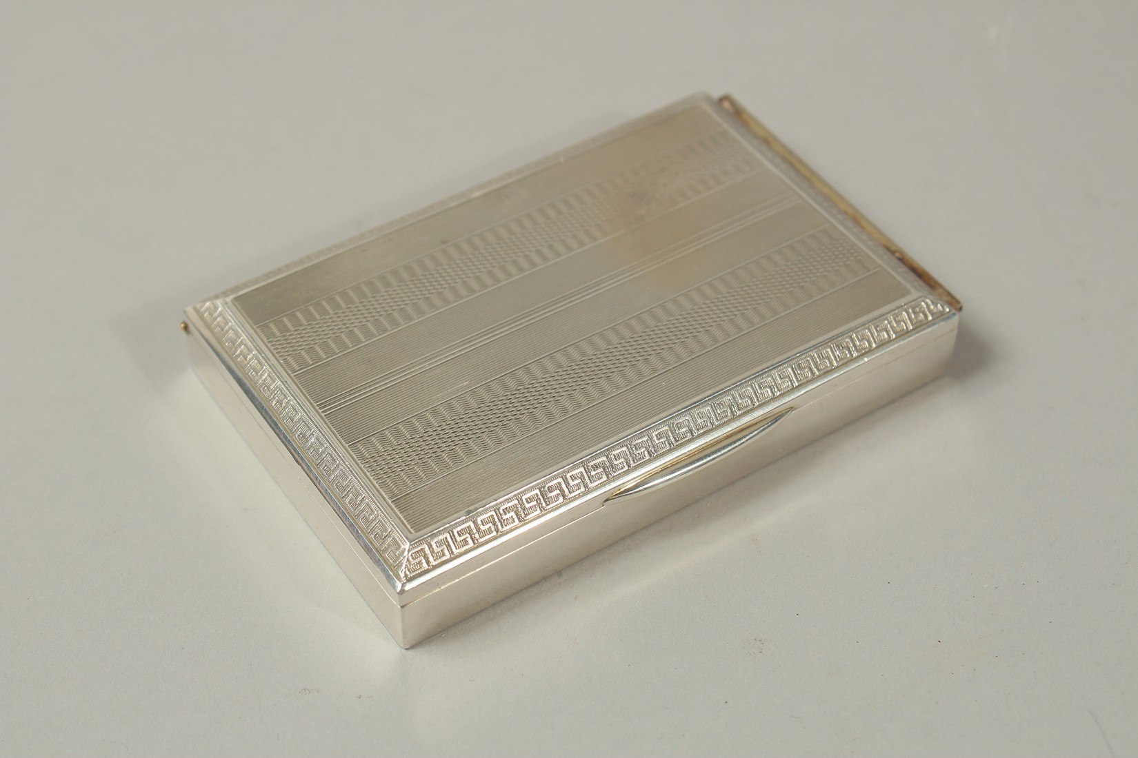 A CONTINENTAL SILVER CIGARETTE CASE with engine turned decoration, the interior of the lid revealing - Image 2 of 3