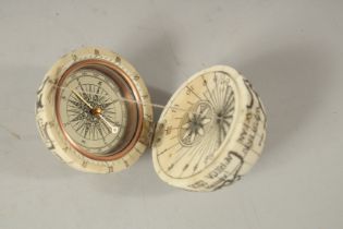 AN ETCHED BONE COMPASS. 6cms diameter.