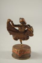 A GOOD AUSTRIAN BRONZE DANCING GIRL lifting her skirt, on a circular base. 13cms high.