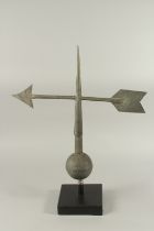 A METAL ARROW WEATHER VANE on a wooden base. 28ins high.
