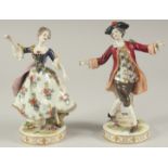 A GOOD PAIR OF PORCELAIN FIGURES OF A GALLANT AND LADY DANCING, on circular bases. 9ins high.