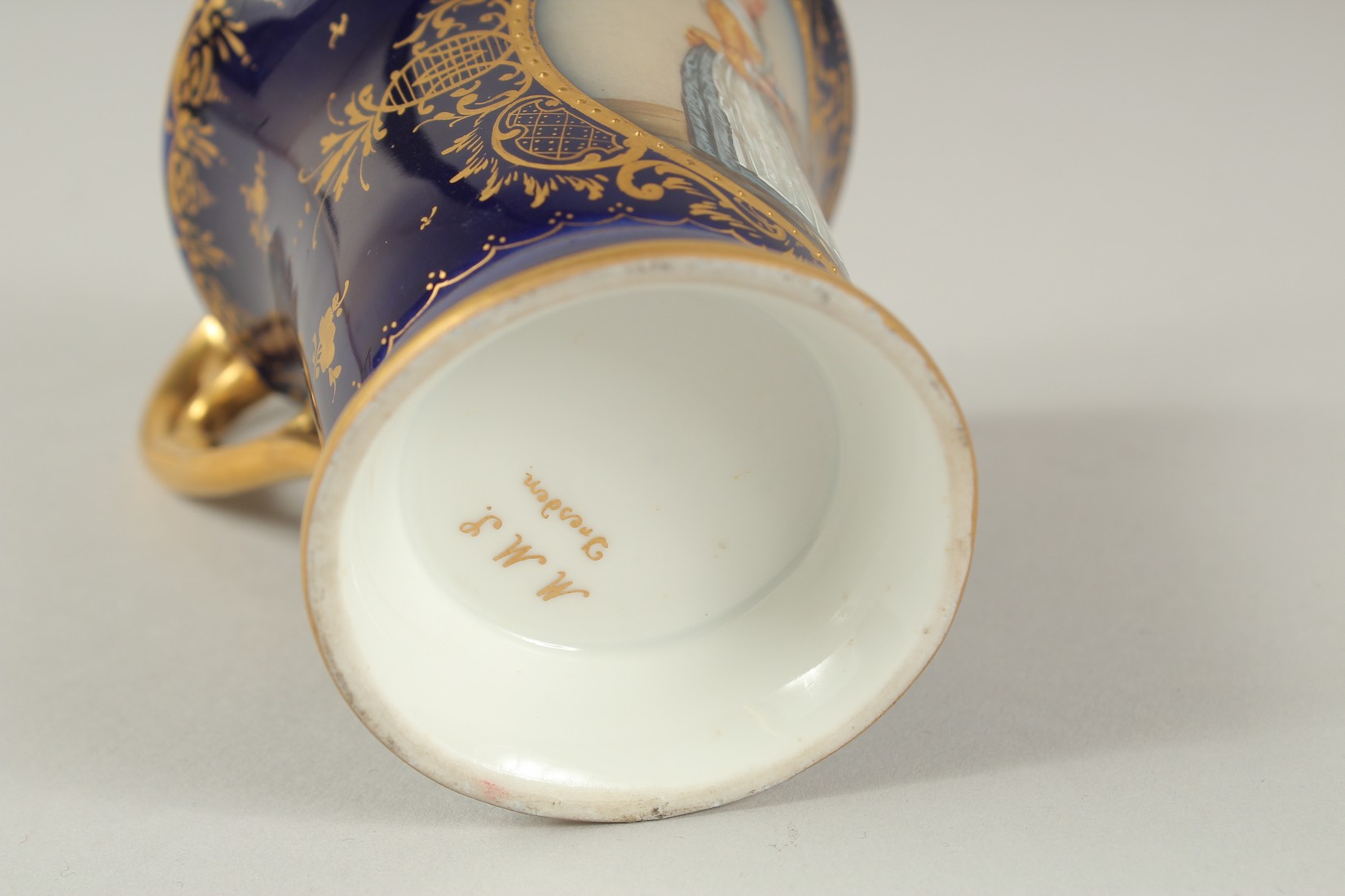 A GOOD DRESDEN CUP AND SAUCER with blue ground, painted with an oval of a lady carrying a tray. - Image 9 of 9
