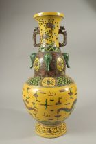 A LARGE CHINESE YELLOW VASE decorated with dragons. 42cms high.