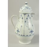 A LARGE VOLKSTEDT COFFEE POT decorated with a stylised flower decoration in under glaze blue. Circa.