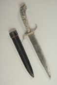 A KNIFE in a leather sheath with lion handle. 12ins long.
