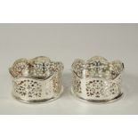 A PAIR OF SILVER PLATE AND FAUX TORTOISESHELL COASTERS.