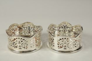A PAIR OF SILVER PLATE AND FAUX TORTOISESHELL COASTERS.