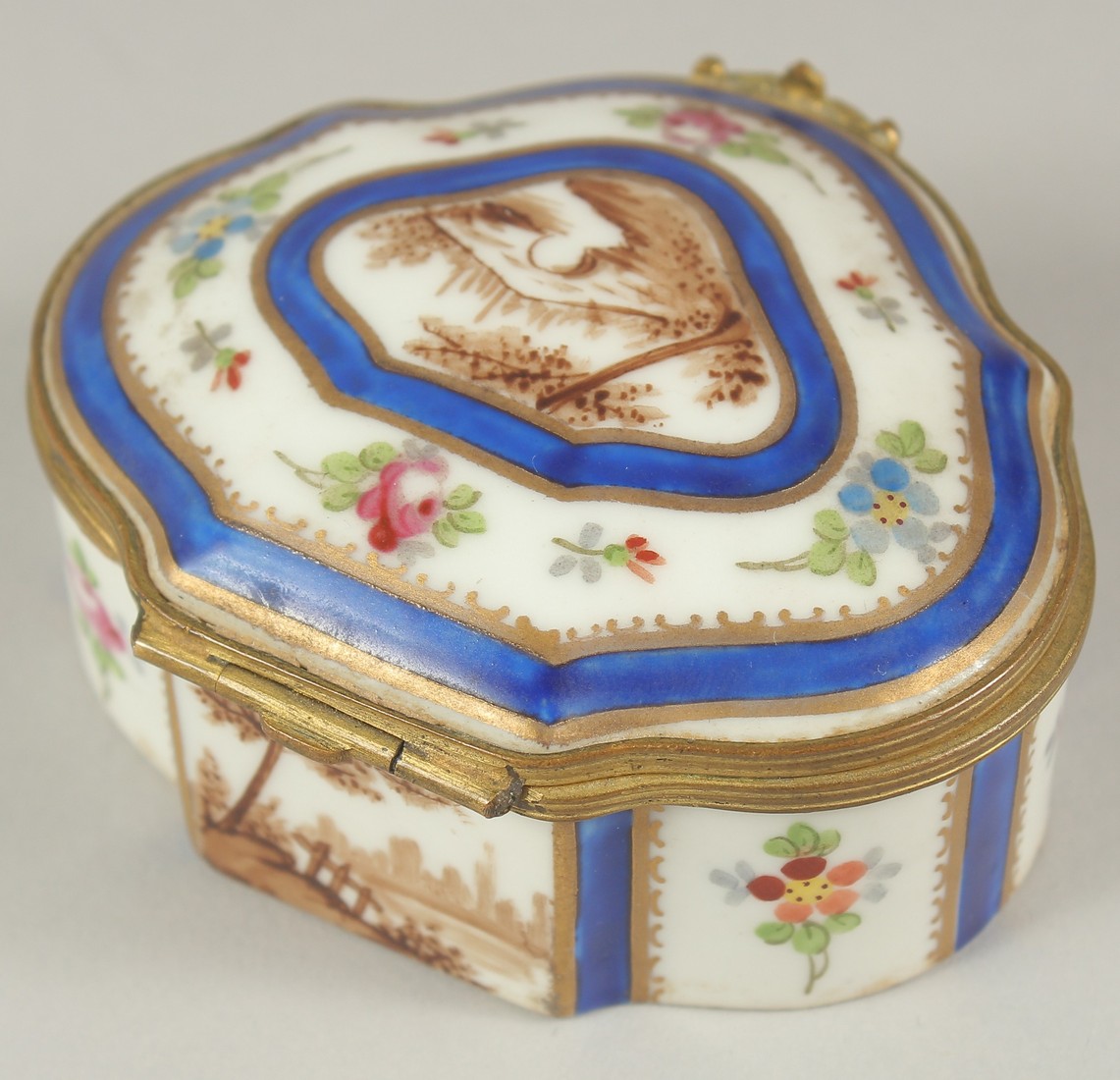 A SMALL SEVRES PORCELAIN PILL BOX AND COVER with blue and white decoration and roses. 3ins wide.