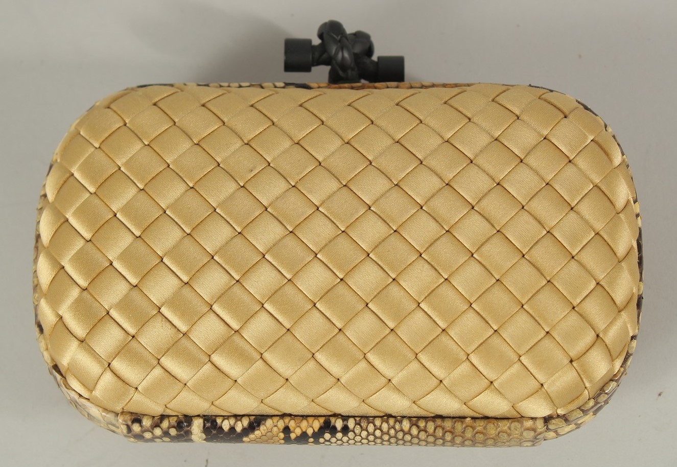 A BOTTEGA VENETA, ITALY, CLUTCH BAG with snakeskin banding. 17cms long, with a dust cover.