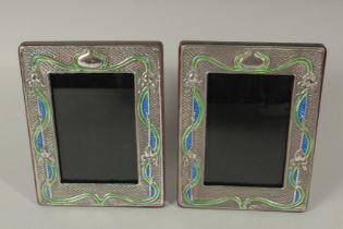 A PAIR OF SILVER AND ENAMEL PHOTOGRAPH FRAMES. 18 x 14cms.