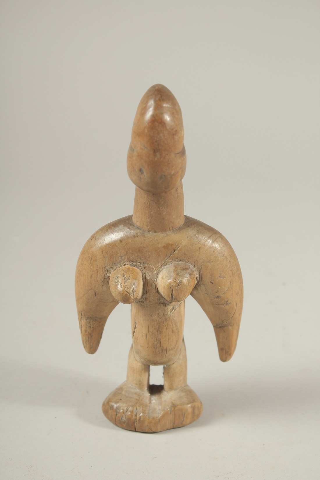 A WORN WOOD FEMALE TRIBAL FIGURE. 7ins high.