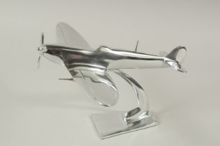 A PLATED SPITFIRE on a stand. 20cms high.