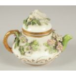 A GOOD SMALL ROCKINGHAM TEAPOT encrusted with flowers. Rockingham mark in puce. 3.5ins diameter.