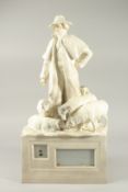 A LARGE WHITE POTTERY SHEPHERD AND SHEEP. 23cms high.