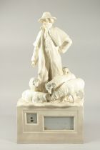 A LARGE WHITE POTTERY SHEPHERD AND SHEEP. 23cms high.