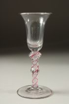 A GEORGIAN WINE GLASS with inverted bell bowl and colour twist stem. 5.5ins high.