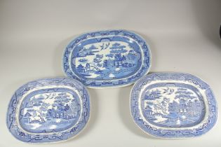 THREE BLUE AND WHITE WILLOW PATTERN MEAT DISHES. 19ins and 16ins pair (3).