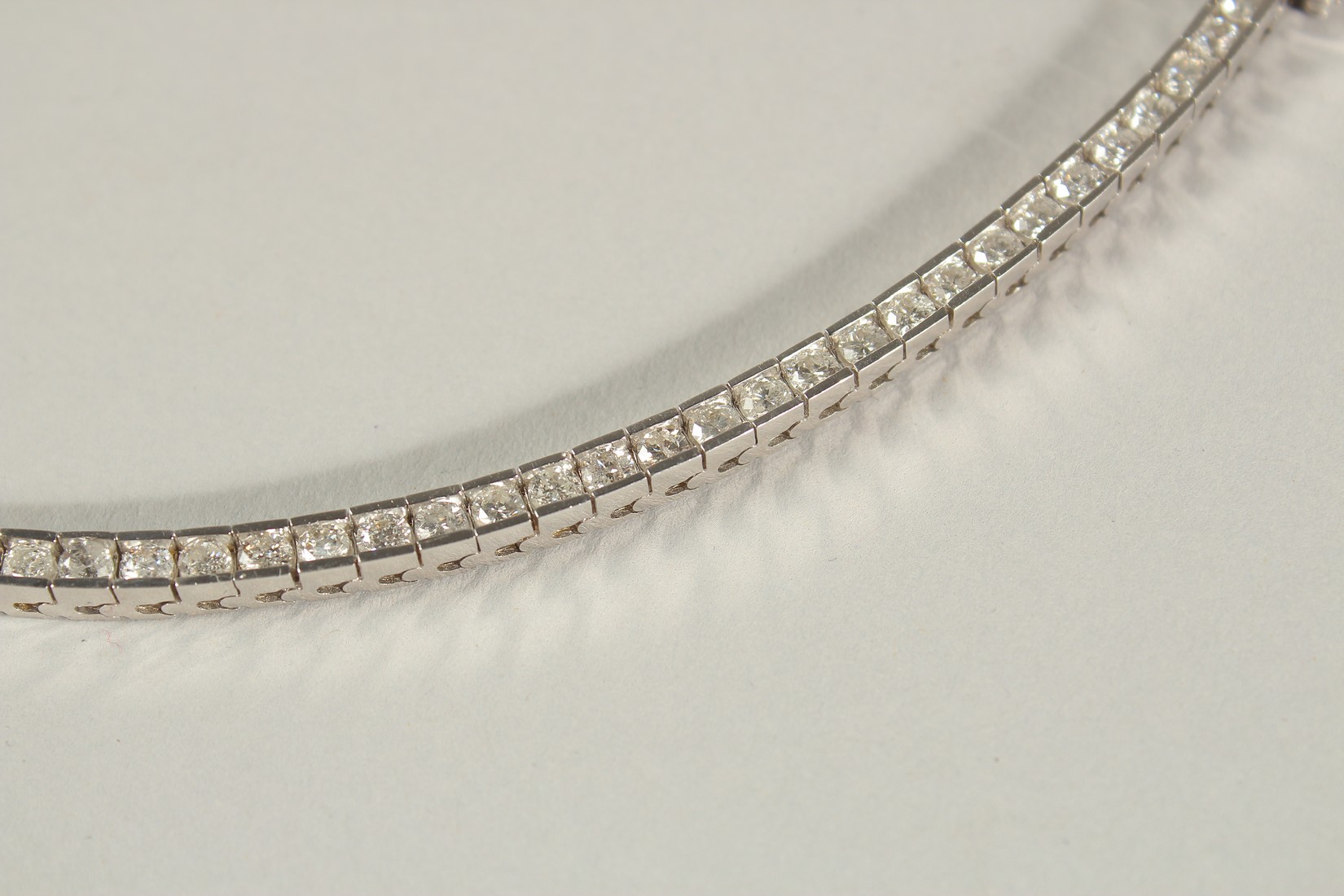 A 14CT WHITE GOLD SEMI-RUBOVER SET RBC DIAMOND LINE BRACELET, with an open blox clasp and safety - Image 3 of 8