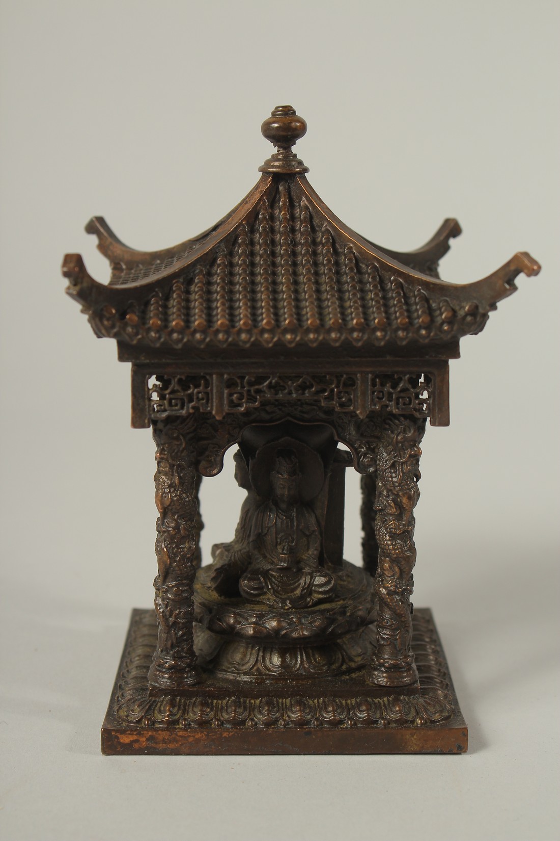 A SMALL BRONZE CHINESE TEMPLE. 14cms high.