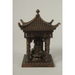 A SMALL BRONZE CHINESE TEMPLE. 14cms high.