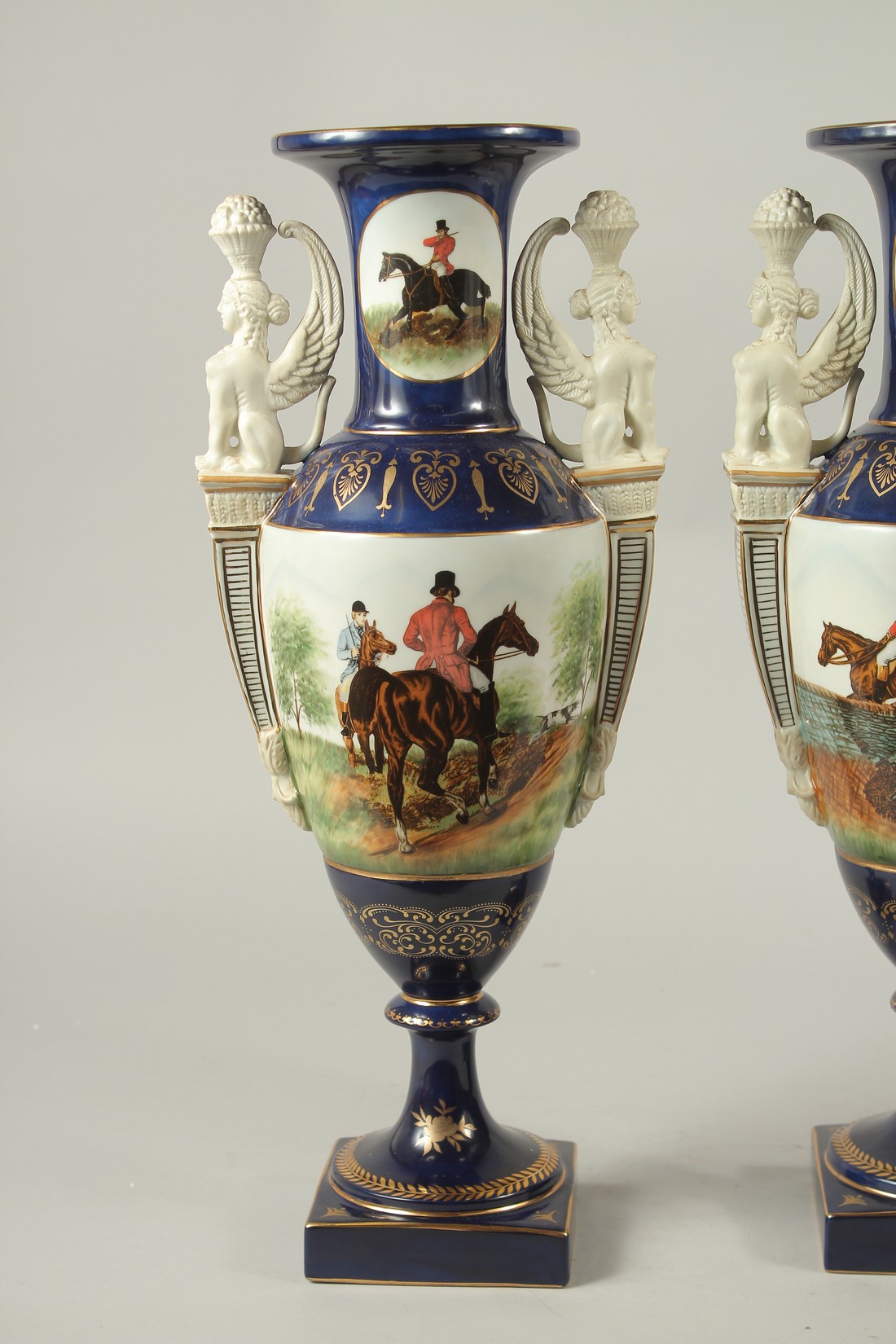 A PAIR OF SEVRES DESIGN BLUE GROUND TWO HANDLED HUNTING VASES. 46cms high. - Image 2 of 5