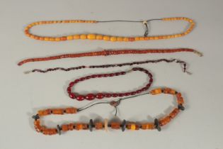 A COLLECTION OF AMBER AND AMBER-TYPE BEADED NECKLACES, (qty).