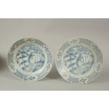 TWO CHINESE WANLI PERIOD BLUE AND WHITE HATCHER CARGO PLATES, with peacock design to centre, 26.