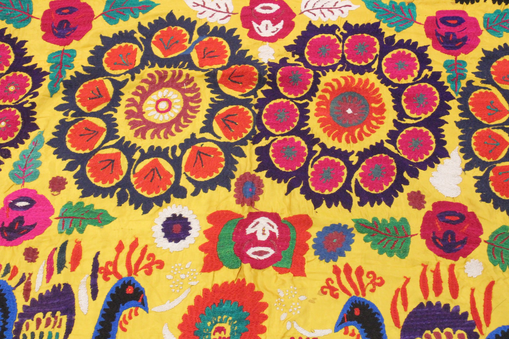 AN UZBEK SUZANI EMBROIDERED TEXTILE, with vibrant polychrome decoration of peacocks and blossoming - Image 4 of 5