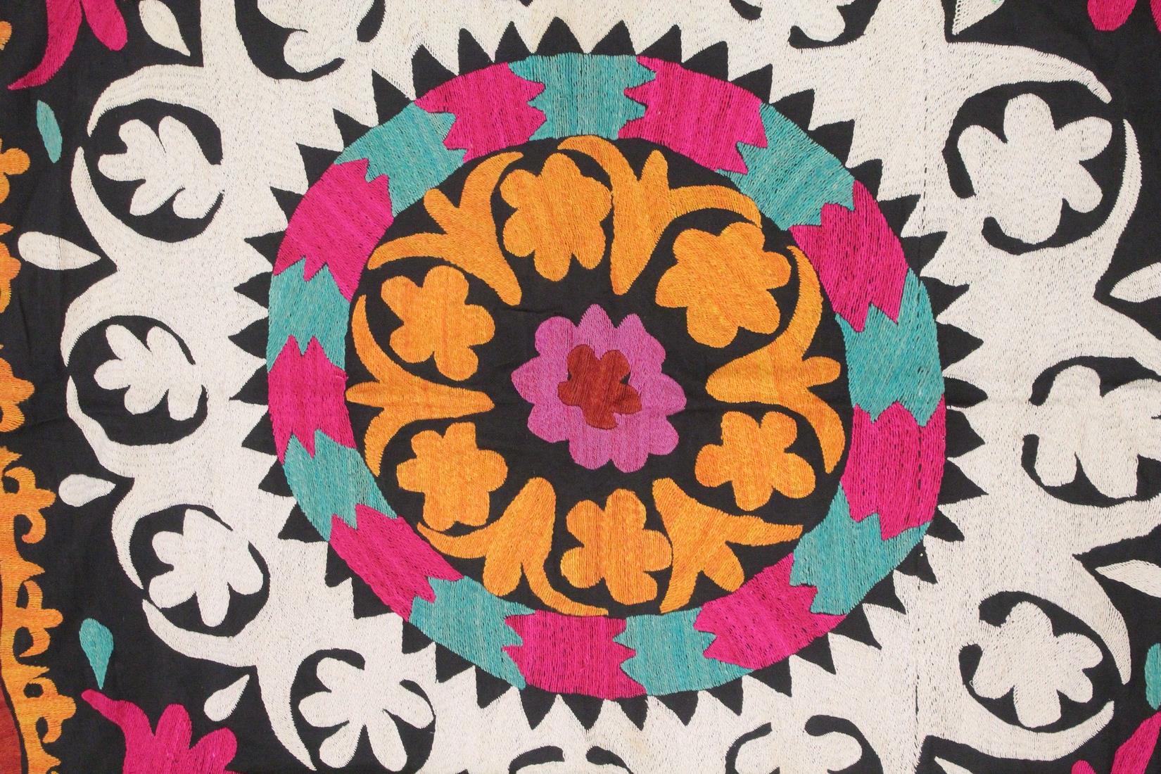 AN UZBEK SUZANI EMBROIDERED TEXTILE, with central foliate motif in orange, pink, red, green, - Image 2 of 3