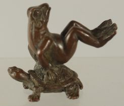 A BRONZE OKIMONO OF A FROG UPON A TURTLE, 4cm high.