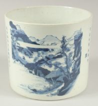 A CHINESE BLUE AND WHITE PORCELAIN BRUSH POT, painted with landscape scene and calligraphy, the base