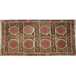 A VERY LARGE 20TH CENTURY SAMARKAND UZBEKISTAN WEDDING SUZANI TEXTILE, in light browns and reds on