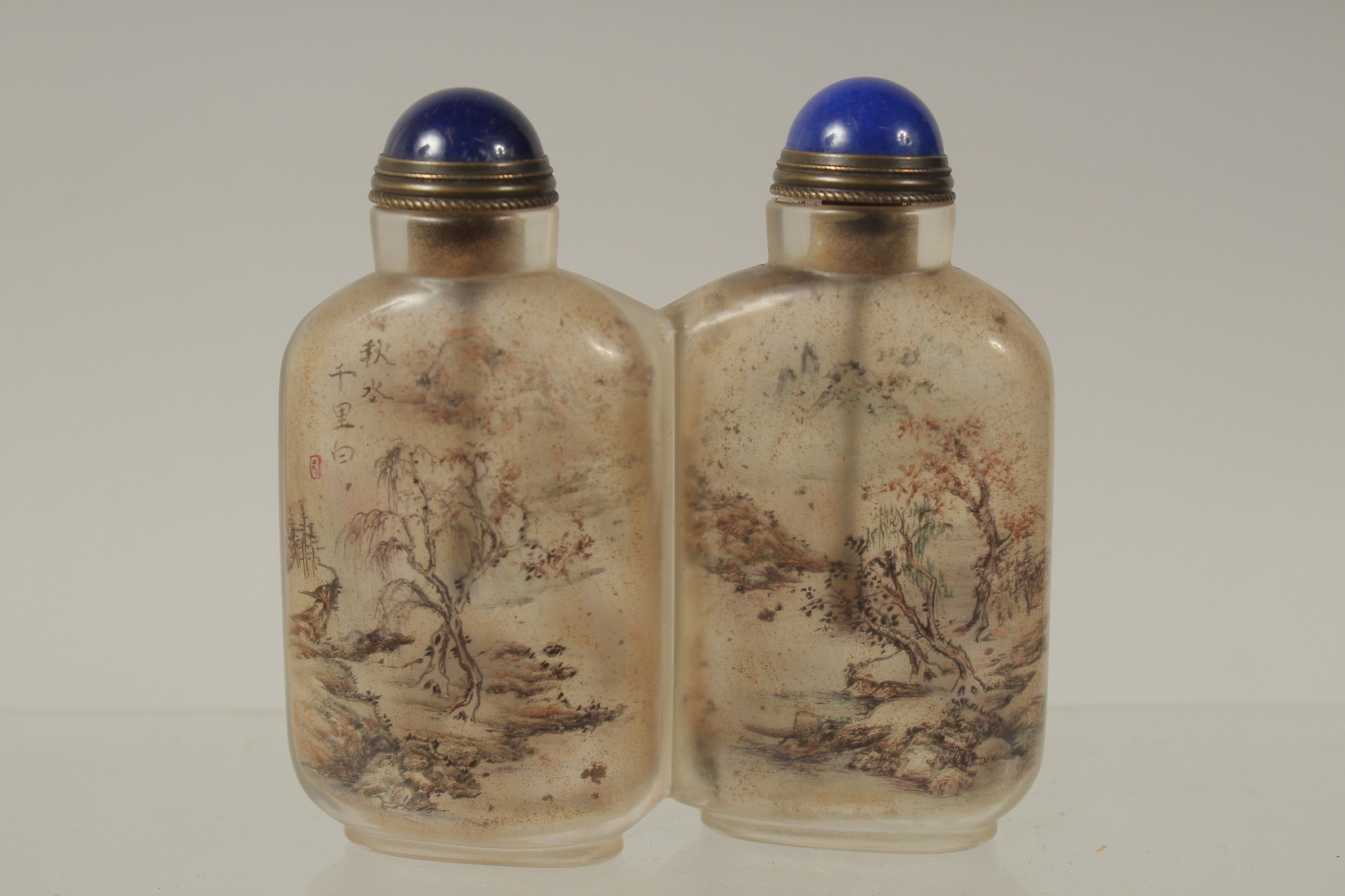 A CHINESE REVERSE GLASS PAINTED DOUBLE-SNUFF BOTTLE AND STOPPERS, finely painted with a landscape - Image 2 of 3