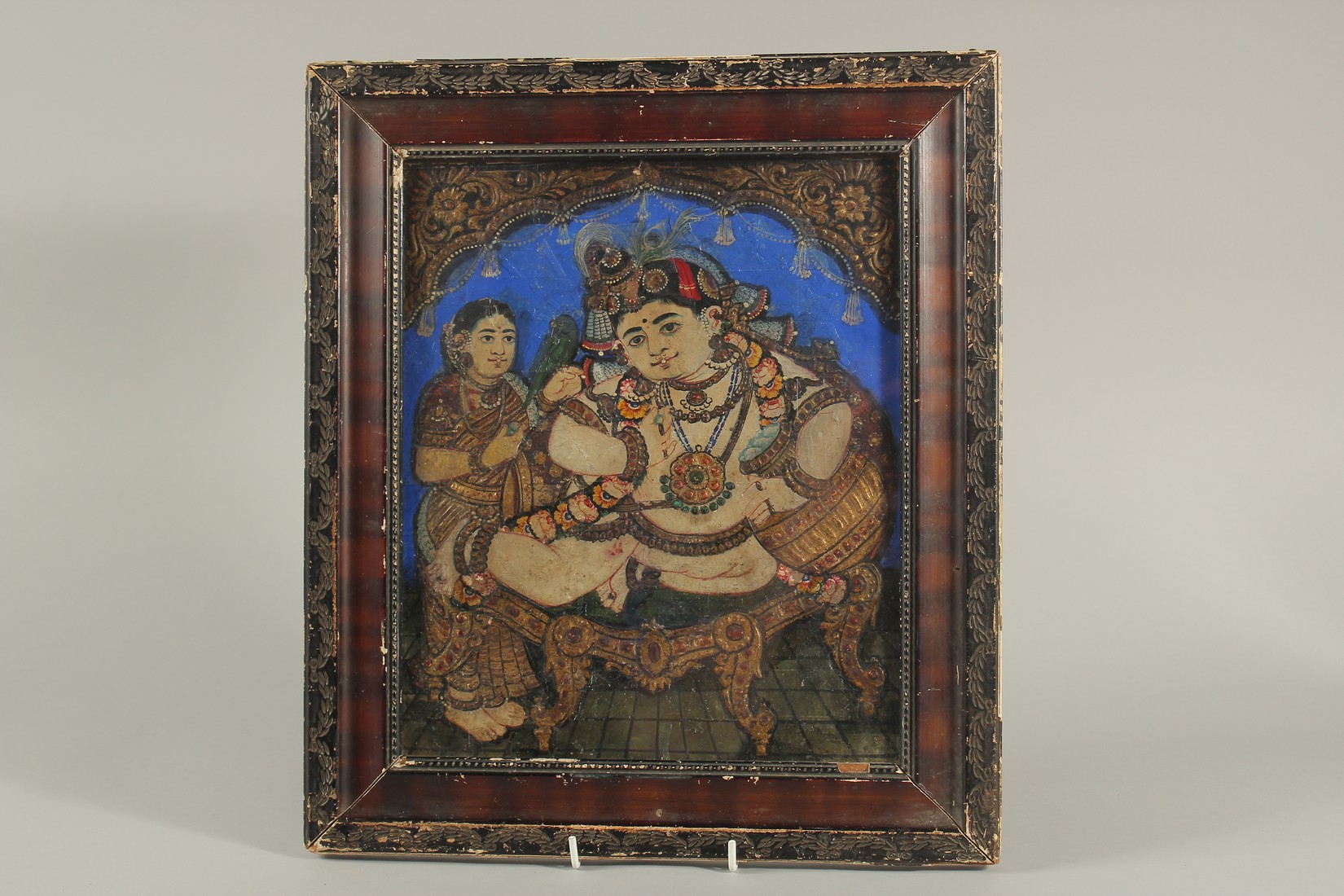 A FINE 19TH CENTURY SOUTH INDIAN TANJORE PAINTING OF ENTHRONED BABY KRISHNA, 39cm x 34cm overall.