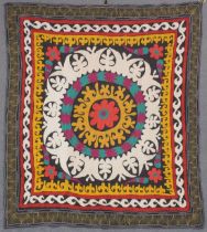 AN UZBEK SUZANI EMBROIDERED TEXTILE, with central floral motif in yellow, orange, green, purple, and