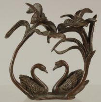 A BRONZE OKIMONO GROUP OF TWO SWANS, beneath an arch of flora, 9cm high.
